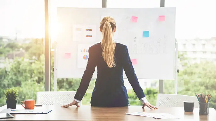 Woman staring at the future plan board