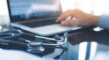 Male doctor hand working on laptop computer