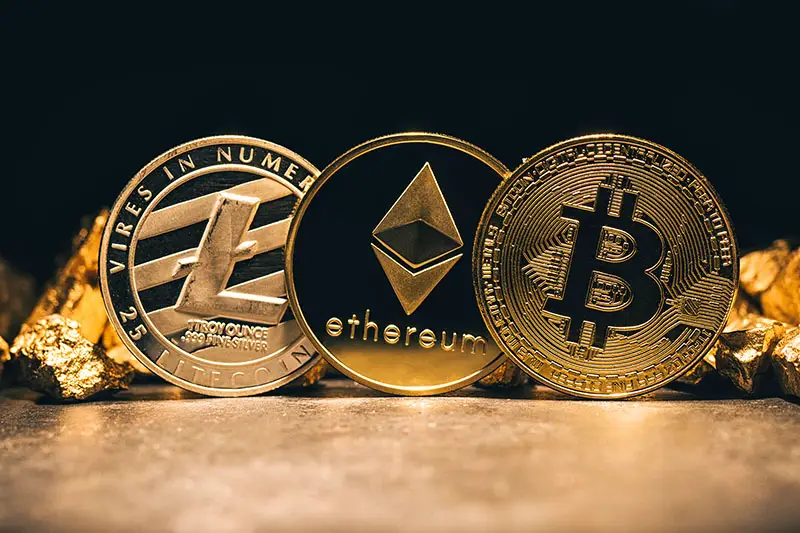 Golden cryptocurrencys Bitcoin, Ethereum, Litecoin and mound of gold