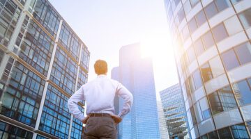 career concept, business background, man looking at office buildings