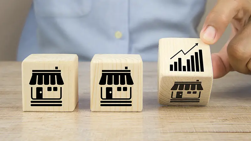 Close-up hand choose graph icon on cube wooden toy blocks