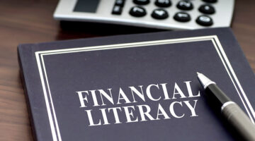 Financial Literacy book with pen and calculator