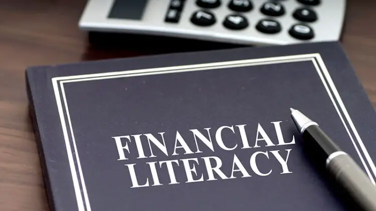 Financial Literacy book with pen and calculator