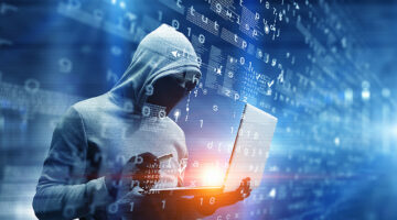 Hacker man with laptop in hands