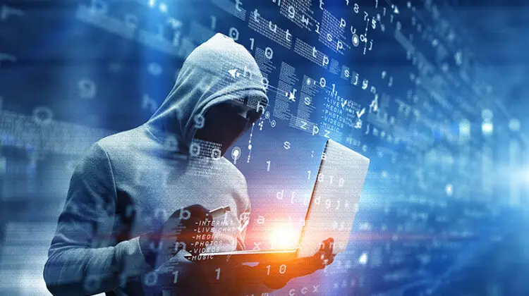 Hacker man with laptop in hands