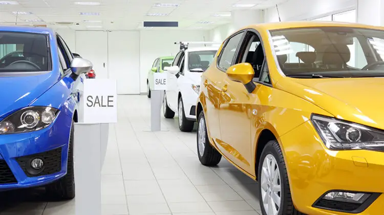 Commercially colourful shining cars stand in light car shop.