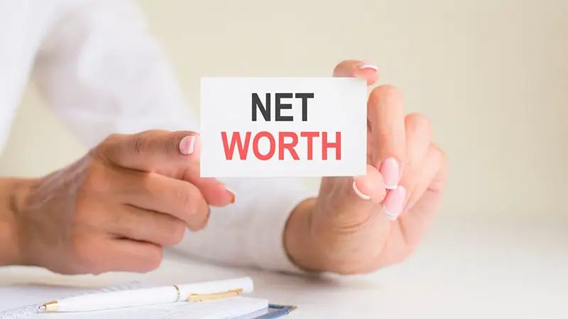Net worth text on small white piece of paper