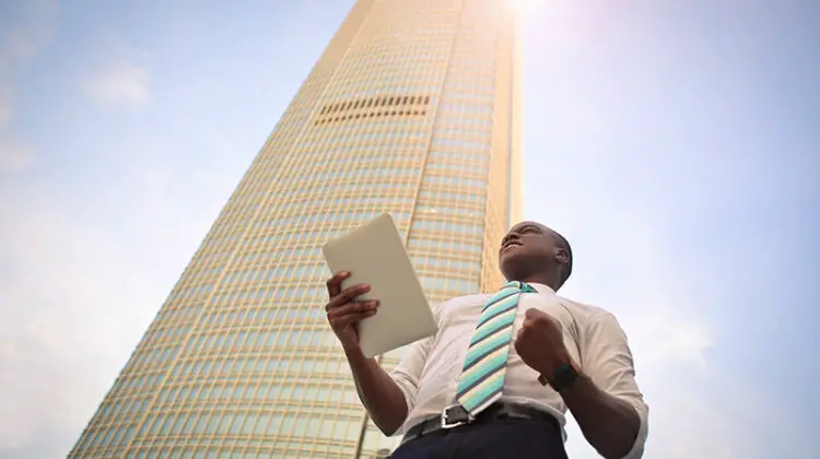 man standing near high-rise building