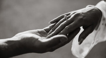 Hand of a woman wearing engagement ring