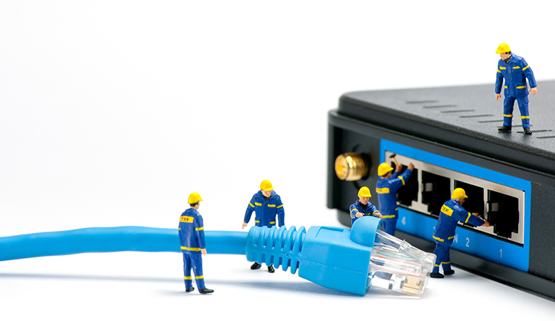 Technicians connecting network cable. 