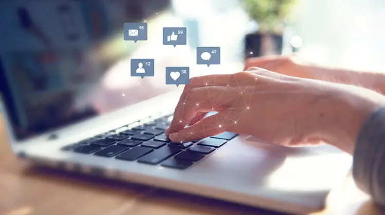 Businesswoman hands using laptop with icon social media and social network, Marketing concept.