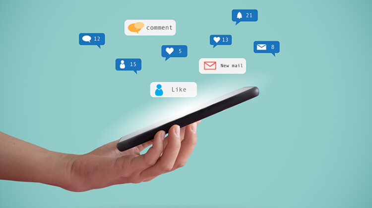 Hand hold smartphone play social media with communication icon.