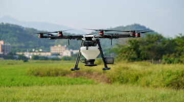 Agriculture white drone in the middle of the field