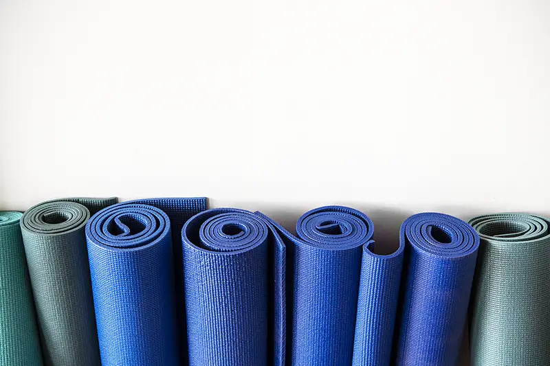 Rolls of yoga rubber mats at a fitness center