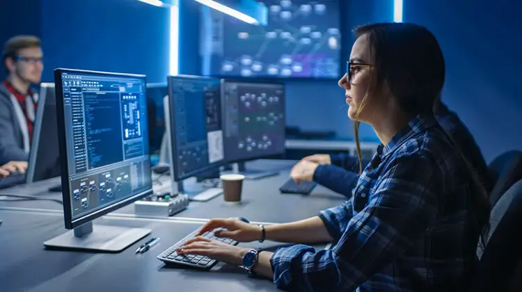 Young Female IT Programer Working on Desktop