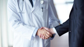 a doctor shaking hands with patient