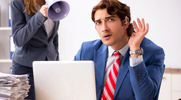 Deaf employee using hearing aid talking to boss