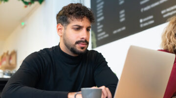 A bearded man using a laptop