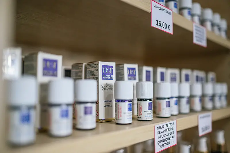 White plastic medicine bottles on wooden shelf