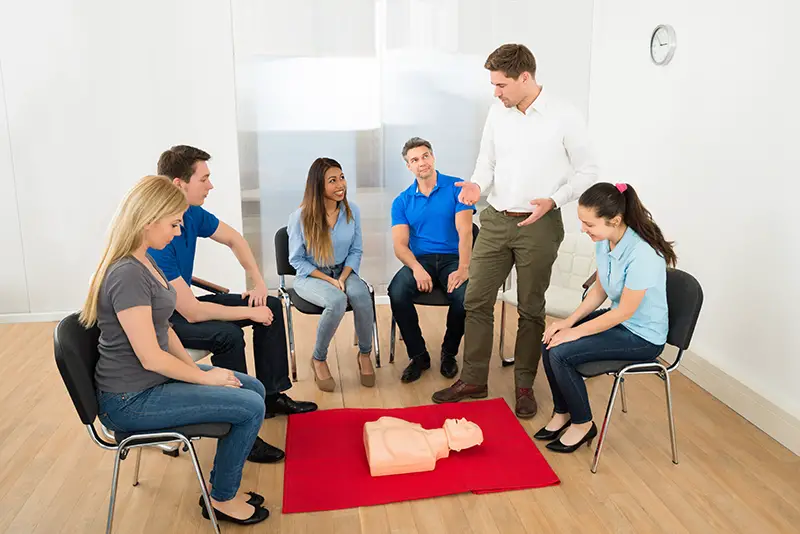 First Aid Instructor Demonstrating Cpr Life Saving Techniques