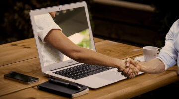 Handshake near laptop