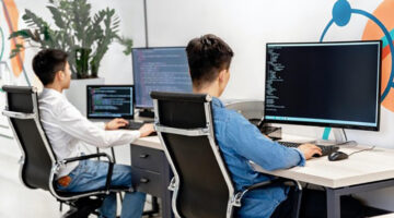 Two young male working in front of their computer