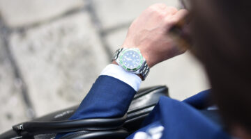 Person looking at silver analog watch