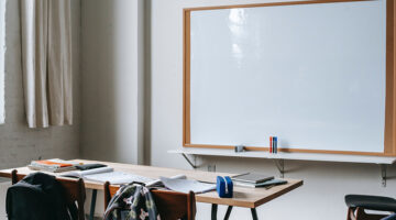 School bench with stationery in classroom