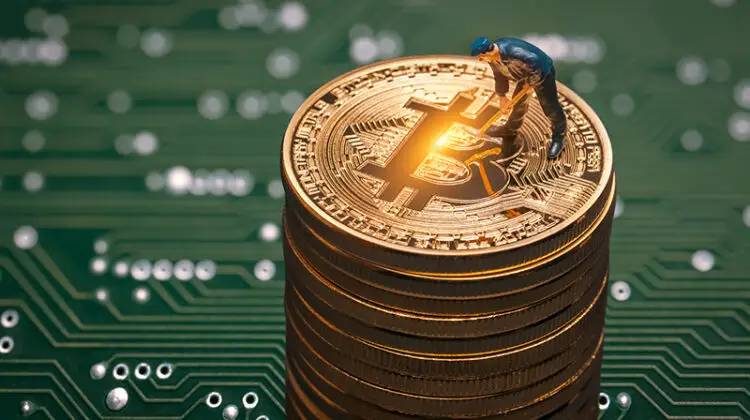 macro miner figurine on shiny bitcoin stack