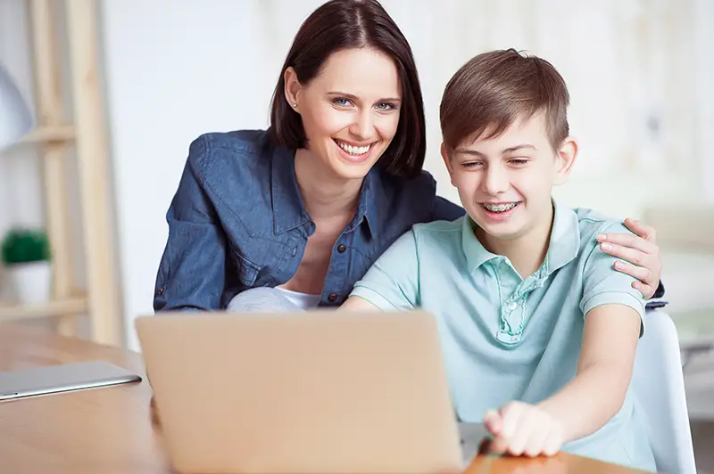 Mother and son in front of laptop