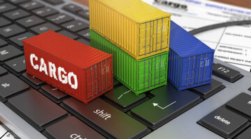 Toy container ban beside black laptop keyboard