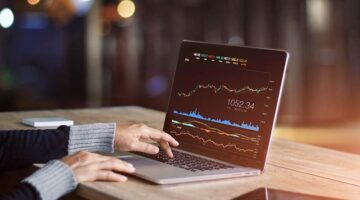 Businessman using laptop for analyzing data stock market