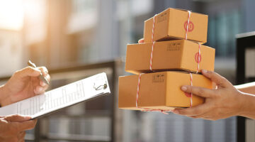 Delivery man holding parcel boxes