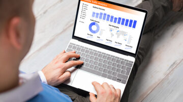 Man viewing website traffic analytics data on laptop computer