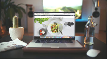 Photo of restaurant website rendered on a laptop on a desk.