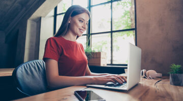business woman sitting in workstation using portable computer device