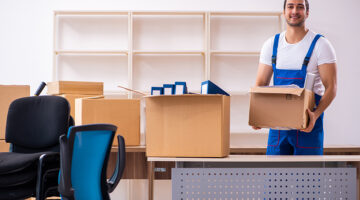 Young male professional mover doing home relocation