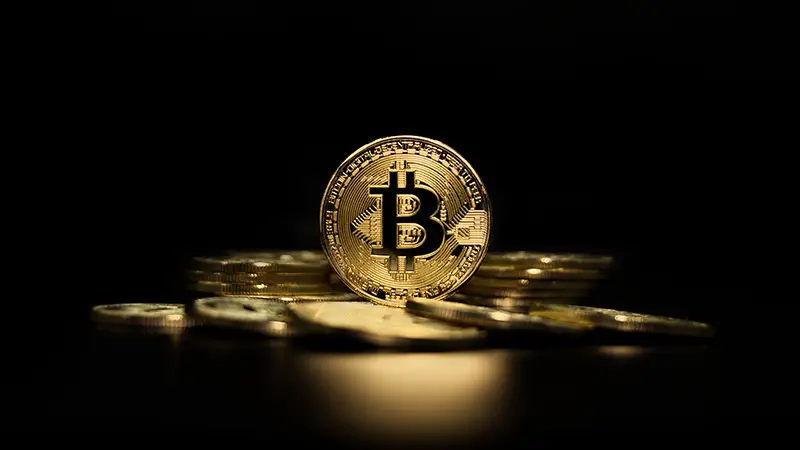 Gold bitcoin in a dark background