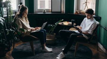Two persons using their gadgets