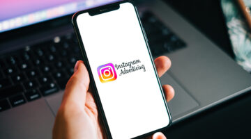 Instagram ads logo on the smartphone screen