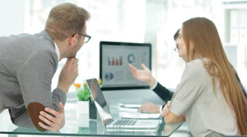 business team works with project statistics data using a laptop