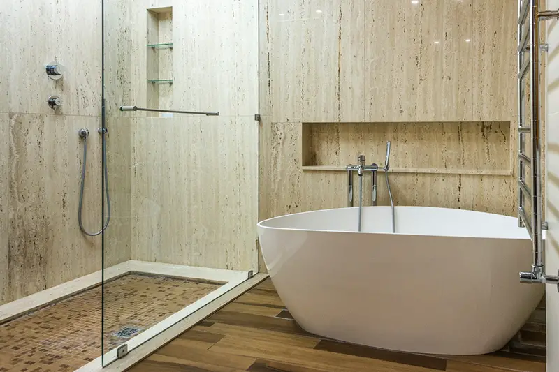 White bathtub inside light brown wall bathroom