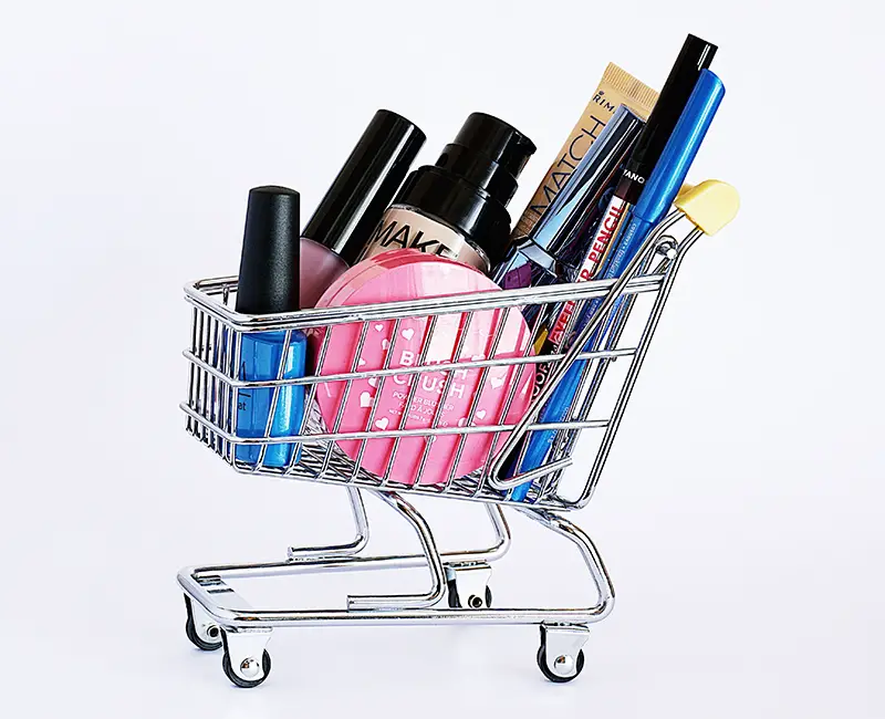 assorted cosmetic products in a mini cart