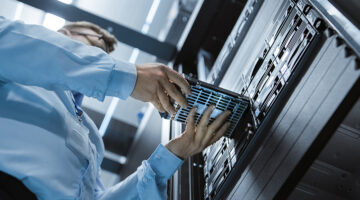 Working Data Center IT Engineer Installs Hard Drive into Server