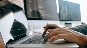 Close up of hands contemporary website developer man typing and writing code