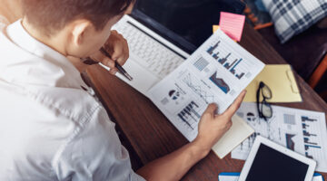 Businessman hold pen and working calculate data