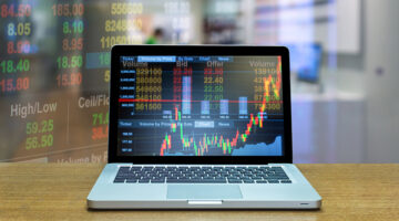 Stock exchange market trading graph over the screen of computer laptop