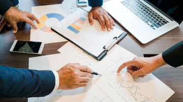 Business people meeting hand pointing at business documents