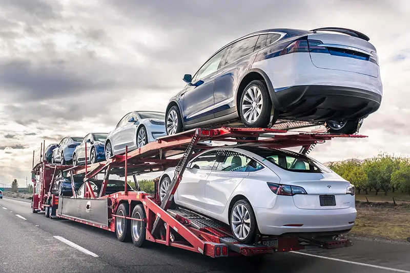 Car transporter carries new Tesla vehicles