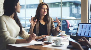 Skilled female leader of marketing experts working in group